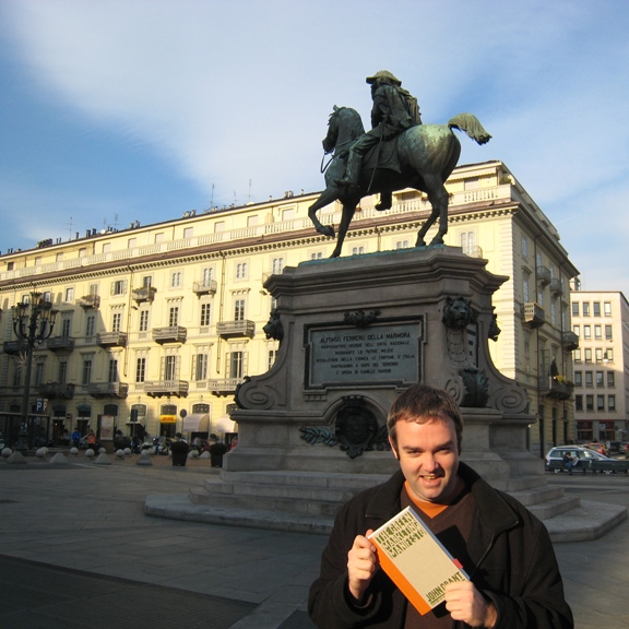 Picture of me holding the Green Marketing Manifesto in Piazza Bodoni