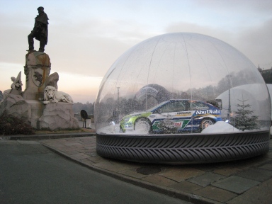 Photo of a car trapped in a bubble with artificial snow